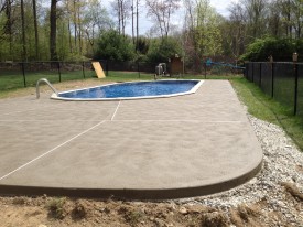Concrete patio around sunken above ground pool